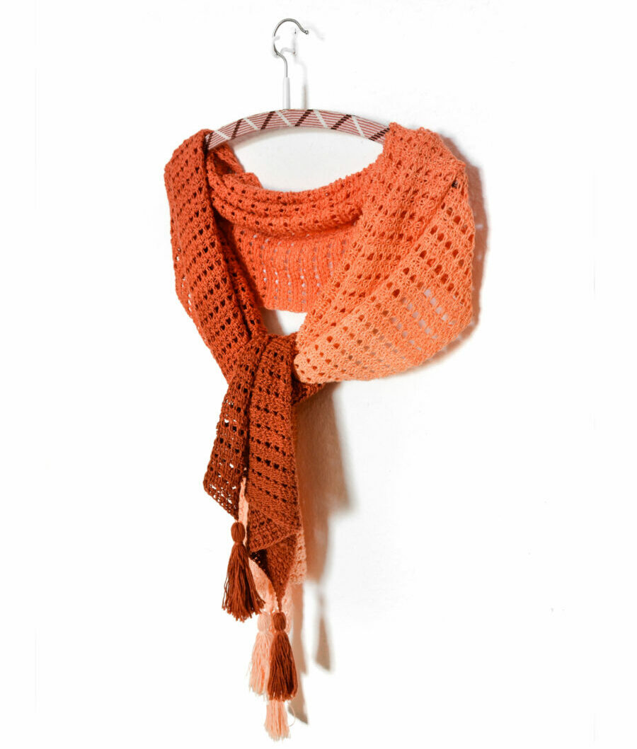 How to make different shawl shapes in Tunisian crochet 5 Orange gradient rectangle Tunisian crochet wrap with the gradient going from one narrow edge to the other, with rows of eyelets and tassels.