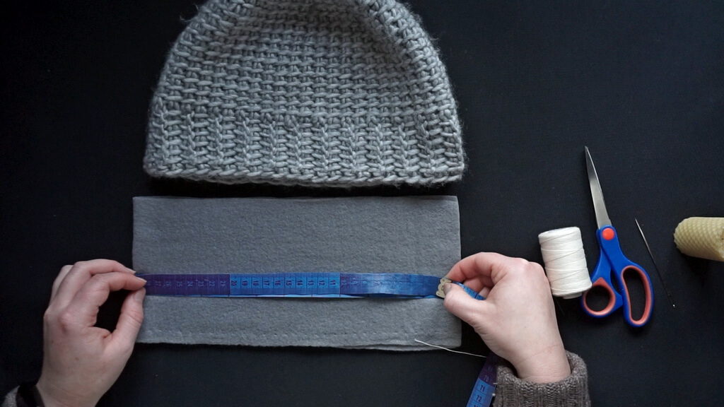 How to line a crochet beanie with fleece 2 Checking the length of the fabric lining by using the measuring tape.