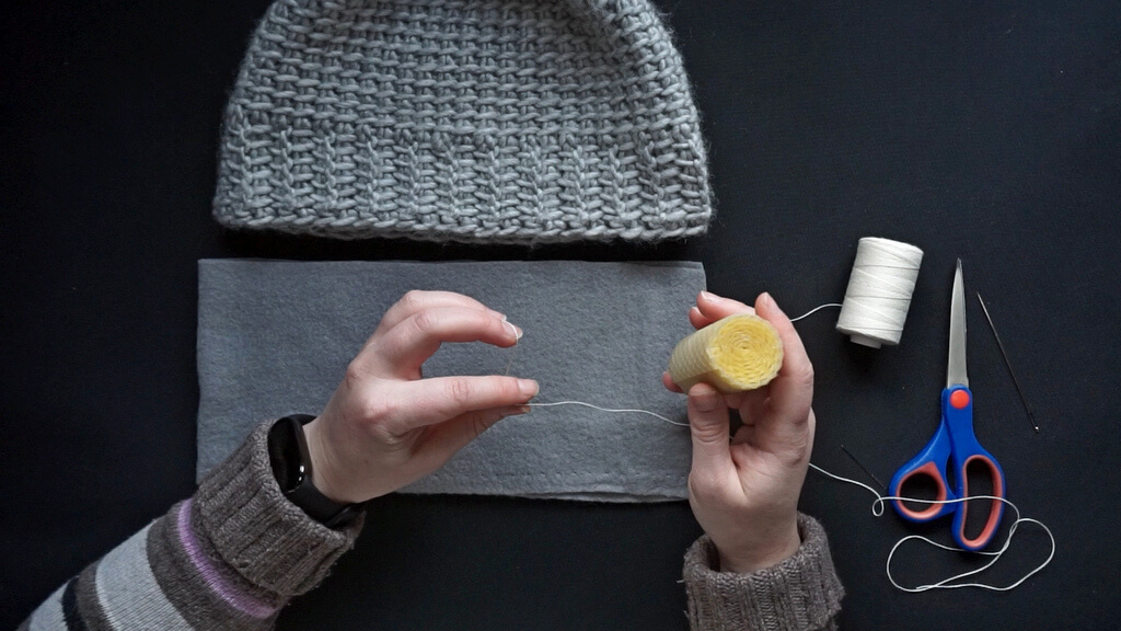 How to line a crochet beanie with fleece 4 Waxing the thread.