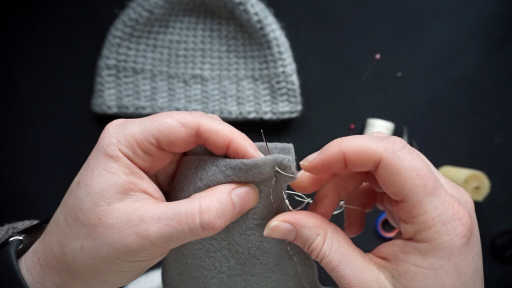 How to line a crochet beanie with fleece 8 Finishing the back stitch seam.