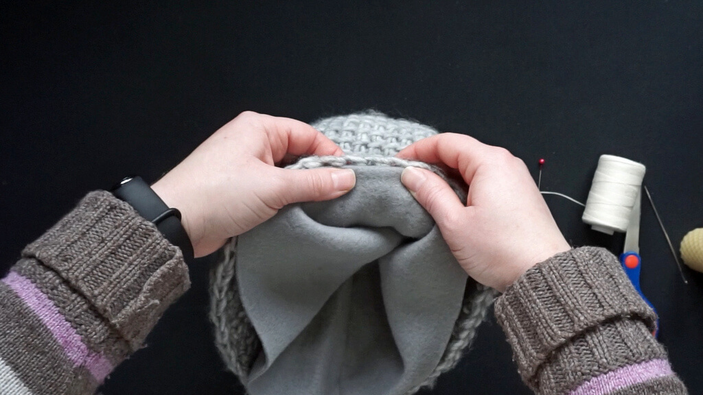How to line a crochet beanie with fleece 17 Folding the edge towards the inside.