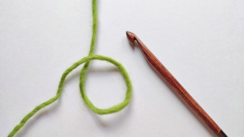 How to start a Tunisian crochet project in a magic ring 2 First step in starting a Tunisian crochet project in a magic ring, making a loop with the working yarn under the yarn end.