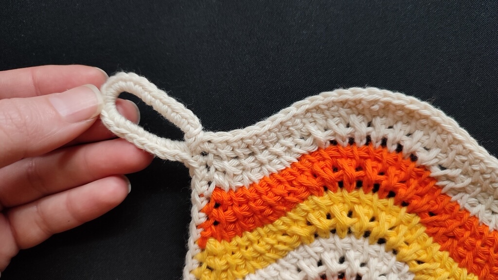 Feather and fan Tunisian crochet pattern for a washcloth 9 Loop for hanging the washcloth on a hook in the kitchen, for easy access.