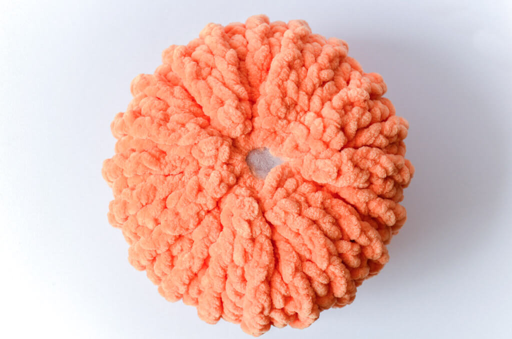 Free crochet pumpkin pattern 11 Finished and stuffed pumpkin seen from the top, waiting for the stem.