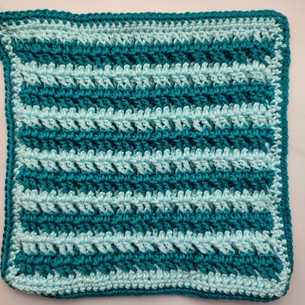 Easiest waffle stitch crochet washcloth or potholder 3 Back of two-color waffle stitch, showing the pairs of front post double crochet stitches, which create a smooth fabric.