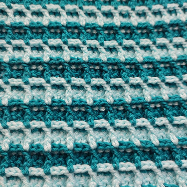 Easiest waffle stitch crochet washcloth or potholder 2 Close up of two-color waffle stitch washcloth, showing the textured side.