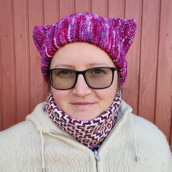 Tunisian crochet cat ear beanie free pattern 1 Tunisian crochet cat ear beanie made in variegated pink fingering weight yarn, worn together with a mosaic crochet cowl in white and variegated red fingering weight yarn.The square points of the beanie stand up on the sides of the head, resembling the ears of a cat.