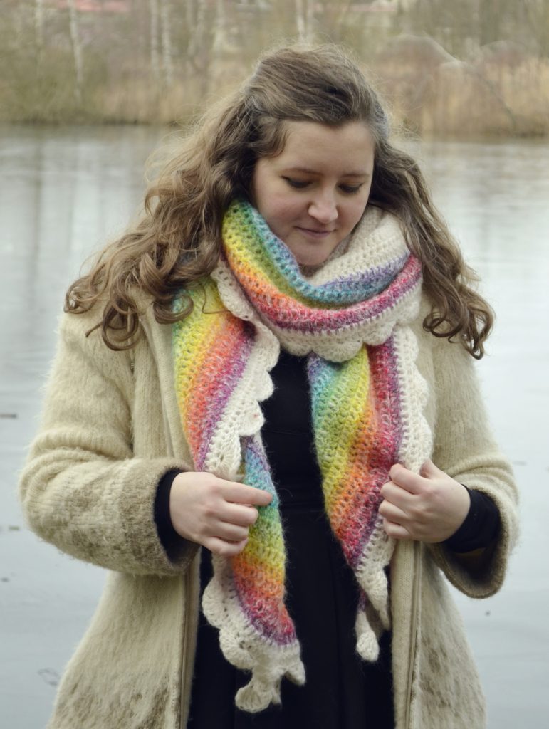 Crochet rainbow shawl worn as a regular scarf, wrapped around the neck, with the colors overlapping