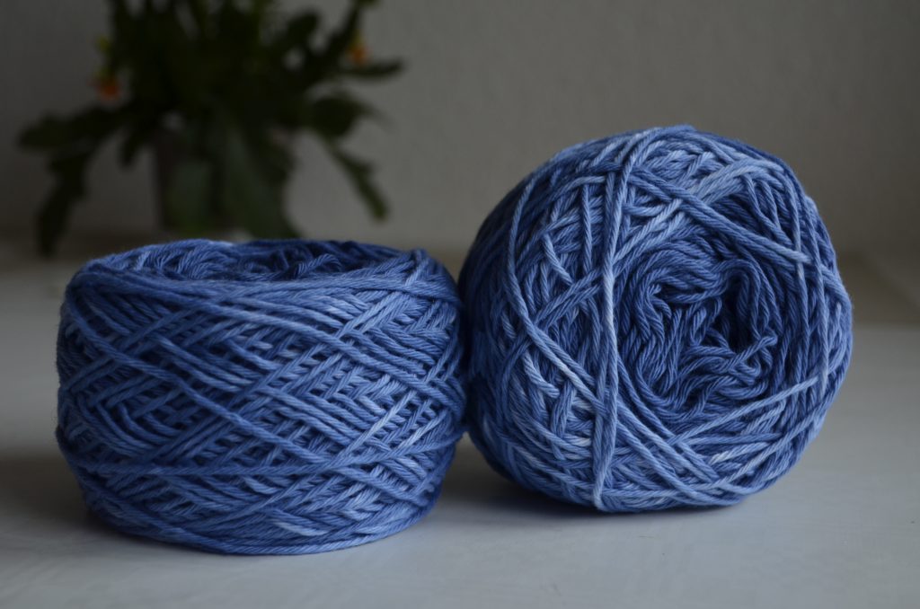 DIY gradient yarn showing two cakes of yarn dyed together
