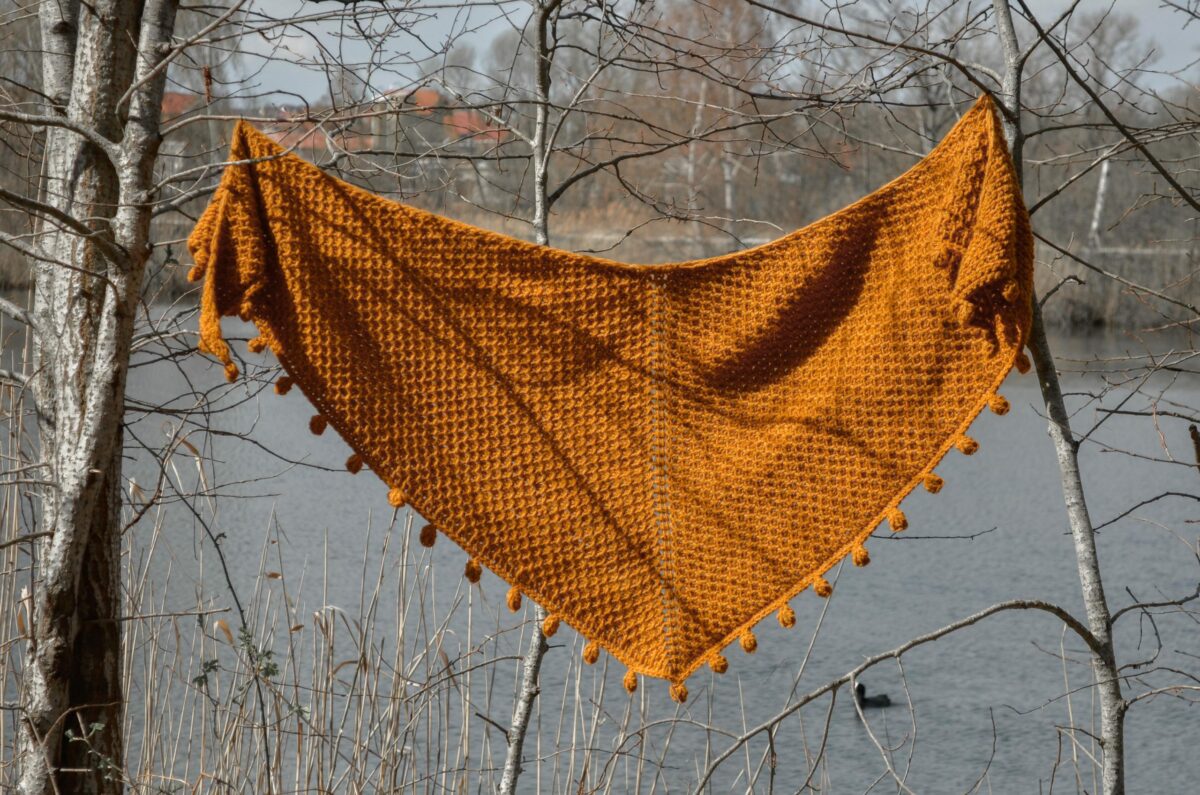 Limonite - Tunisian crochet shawl hanging and showing the crescent shape