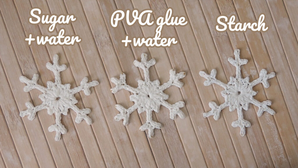 Three snowflakes, one stiffened with sugar, one with PVA glue, one with starch