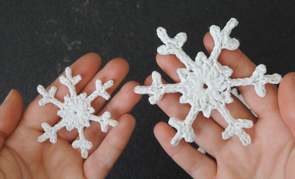 Two snowflakes, one larger meant as a tree decoration; one smaller, meant as a future earring