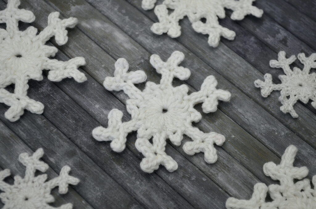 Unstarched crochet snowflakes on a grey surface
