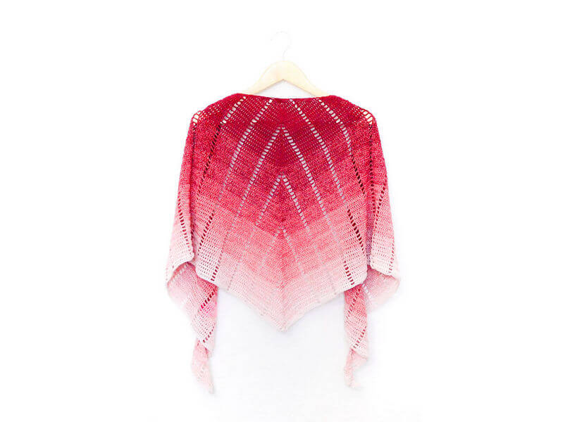 Raspberry croissant shawl - free crochet pattern with video 1 Raspberry croissant shawl on a hanger showing the back view or the spine of the shawl