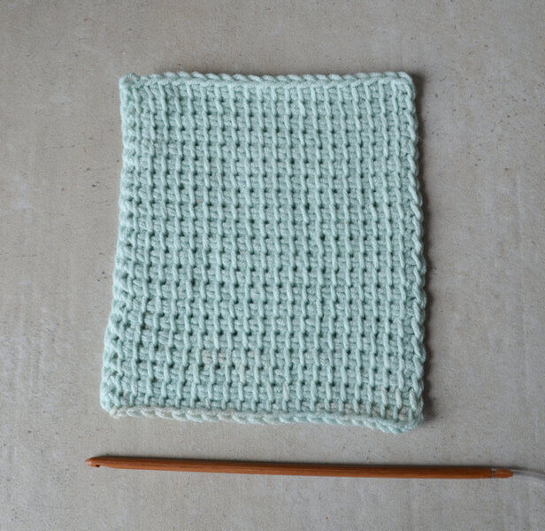 Tunisian crochet sample with 4 mm hook next to it