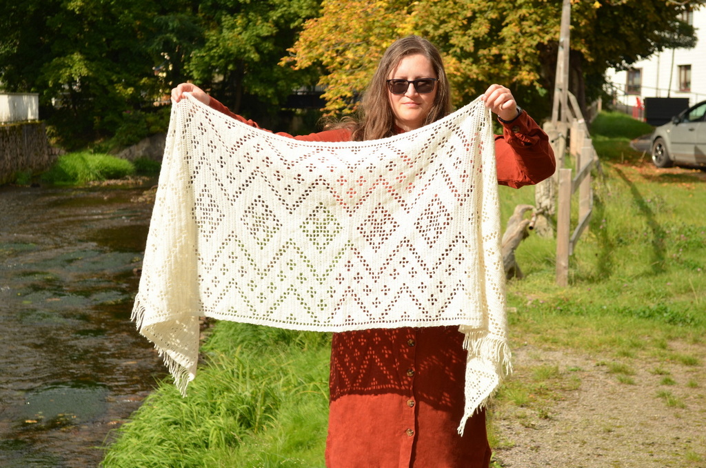 Dolina wrap that uses extended double crochet stitches to create symmetrical motifs in the pattern 