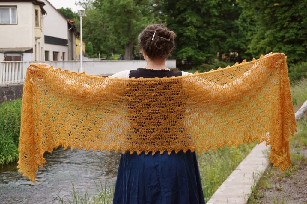 Showing the drape of the wheat fields shawl lace made with Hobbii Diablo