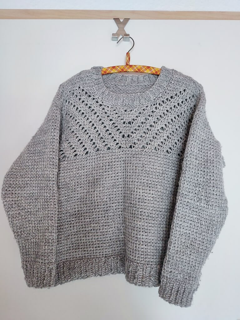 Slate etching sweater on hanger