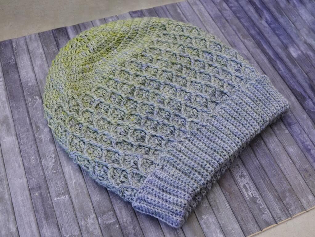 Honeycomb beanie crochet pattern 2 Honeycomb beanie made in fingering weight yarn in a gradient from variegated lime green to light steely blue. The brim is doubled.